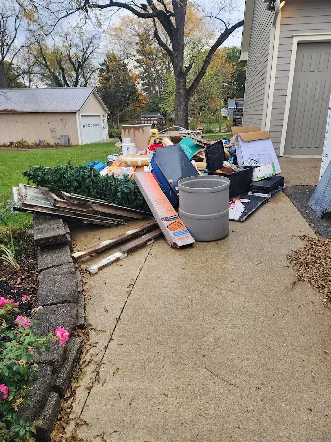 Dumpster being loaded with debris for Estate Cleanout Dumpster Rental in Reedsburg